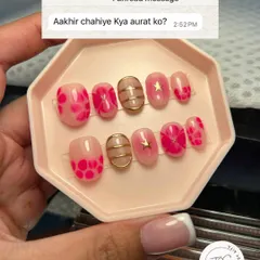 A cute and trendy set of custom press-on nails. This design features a mix of sheer pink floral patterns, gold chrome details, and a star accent. It's a fun way to answer the question, "What does a woman want?"