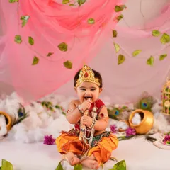 A heart full of joy and a smile that lights up the room. Our themed photoshoots, like this adorable Janmashtami session, are designed to celebrate special occasions and your baby's delightful personality with vibrant, creative setups.