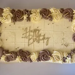 The finished caramel-flavored sheet cake, pre-marked for easy portioning. The border of hand-piped rosettes makes it beautiful from every angle, ready for a big celebration.