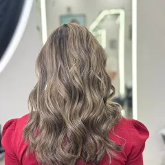 A back view of my smoke blonde classic highlights. This cool-toned blonde adds a sophisticated brightness and depth, styled here in soft waves to showcase the blended colors.