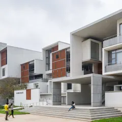 The academic blocks at VIT are designed as a series of interconnected volumes with deep overhangs and recessed windows, creating a play of light and shadow while providing shade.