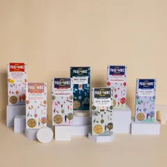 This shot showcases an entire range of artisanal chocolate bars. The neat arrangement on minimalist white blocks creates a clean, modern look that is perfect for a brand's catalogue or website banner.