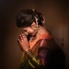 A traditional pose of the bride in a moment of prayer or reflection, highlighting the intricate jewelry and hairstyle from the side.