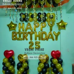 Cheers to 25 years. This stylish room decoration in black and gold is perfect for a milestone celebration, featuring balloon pillars, foil letters, and heart and star accents for a festive touch.