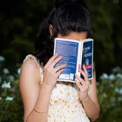 A creative and candid-style portrait. Using a prop like a book can help you relax and allows us to capture a different side of your personality.