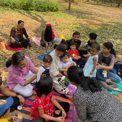 A close-up of children interacting with a zebra hand puppet. Props like these are a wonderful way to bring characters to life and encourage imaginative play during our sessions.