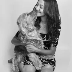 A gentle nuzzle from a sweet Cocker Spaniel. This intimate black and white portrait captures the quiet, loving bond between a girl and her dog.