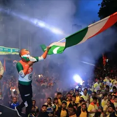 An enthusiastic participant with the Indian tricolor painted on his face waves a flag on stage, with smoke effects adding to the drama. We create an electric atmosphere that fuels the passion of the crowd.
