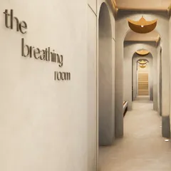 I designed this corridor, named 'The Breathing Room,' to be a transitionary space that prepares you for mindfulness. The repeating arches and soft, indirect lighting guide you through the studio, creating a calming and immersive journey.