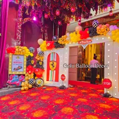 The entrance to a high-energy Ferrari themed birthday party, designed to look like a pit stop with branded doorways and checkered flag details.