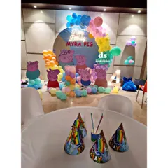 The view from the party table at a Peppa Pig celebration. I ensure every detail, including party hats and table settings, matches the theme to create a cohesive and immersive experience for the kids.