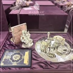 My Pooja Auspicious Hamper, featuring a silver Ganesha idol, a pooja thali, and the Gita Saar, all nestled in a rich purple velvet box.