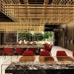 For this Lucknow jewellery showroom, we designed a suspended brass mesh that defines the space and functions as a dramatic lighting installation, contrasting with dark marble and bold red accents.