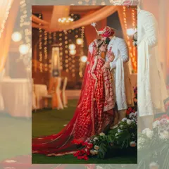 An artistic, softly focused shot of the couple sharing an intimate moment, framed by the warm glow of the wedding decor.