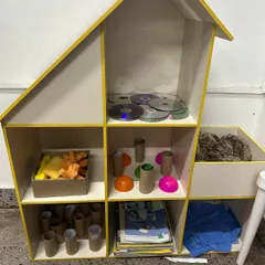 In our Playmaker's Lab, a dollhouse is stocked not with furniture, but with CDs, toilet paper rolls, and fabric scraps. This challenges children to see and create possibilities in the most unexpected materials.