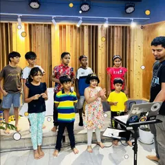 A group of young musicians learning together during our summer camp. We create a fun, collaborative environment where kids can explore their musical interests.