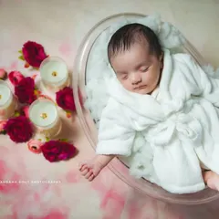 A fun and unique concept for a newborn shoot is this 'Spa Day' theme. Your baby is comfortably posed in a miniature tub with a tiny bathrobe, surrounded by candles and flowers for a truly adorable and memorable portrait.