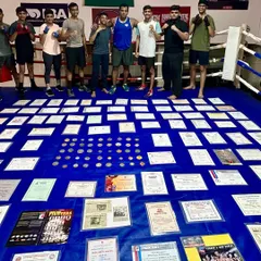 My students standing proud behind my life's work. My goal is to help them start their own collection of medals and build their own legacy in the sport.
