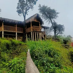 The Vattavada mud house perched on the hillside, offering stunning views and a peaceful retreat.