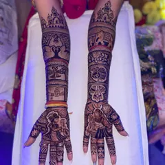 This full-arm design tells a complete wedding story. It includes a doli scene, a tree of life, and the couple exchanging garlands, all rendered in fine detail.