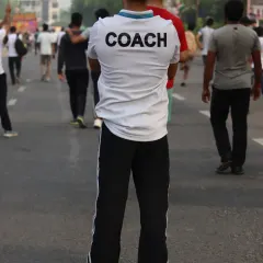 As a coach, I lead by example during a local running event. I am on the ground with my athletes, guiding them through race day, ensuring they apply the tactics and techniques we practice.