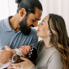 A beautiful portrait of new parents with their baby. The love and awe in their expressions tell the whole story of this new chapter in their lives.