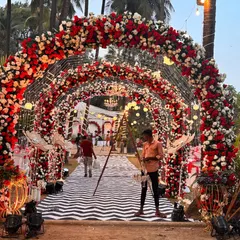 A spectacular "Red Rose" themed wedding entrance. This immersive floral tunnel, made of red and white roses with integrated lighting, creates a breathtaking welcome for a romantic, Valentine-inspired wedding.