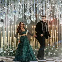 We turn the Sangeet night into a full-blown fairytale. This couple's first dance was set against a backdrop of sparkling disco balls and a classic checkered dance floor, creating a scene of pure energy and joy.