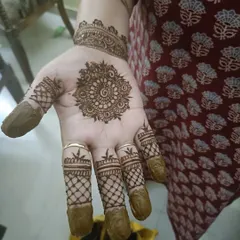 A simple yet elegant mandala on the palm, paired with net designs on the fingers.