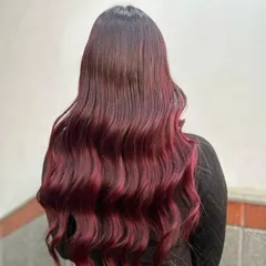 Another angle of the stunning red ombre, capturing how the light hits the waves and makes the color pop. This is a perfect style for making a statement.