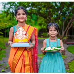 It gives me so much joy to photograph the spirit of our festivals. Here, sisters Nihira and Avani celebrate Ganesh Chaturthi, one holding a beautiful Bappa idol and the other a plate of modaks. These are the precious cultural memories I love to preserve for families.