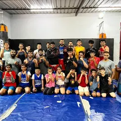 Nothing but gains here. A large group photo showing the diversity of our team, from kids to adults, men and women, all part of the Bengaluru MMA family.