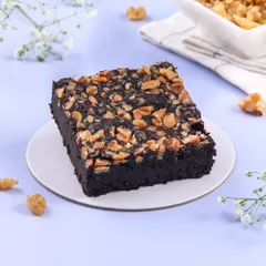 A close-up of my classic Walnut Brownie. It's dense, chocolatey, and packed with crunchy walnuts for a great texture.
