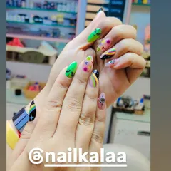 A quirky and colorful "trippy" nail art set. This design features hand-painted aliens, rainbows, and evil eye symbols on a clear base for a fun, eclectic look.