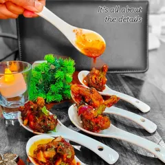 It's all about the details. Here, we are adding the final drizzle of sauce to our Asian-flavored appetizers, ensuring each bite is perfectly balanced and beautifully finished.