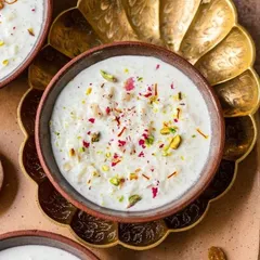 Muttanjan, a traditional sweet rice dish, garnished with pistachios, saffron, and rose petals. This colorful and aromatic dessert is often served at weddings and festive celebrations.