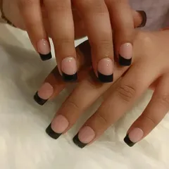 A bold and modern take on the French manicure. This style uses a natural nude base with solid, matte black tips for a high-contrast, edgy, and contemporary look.