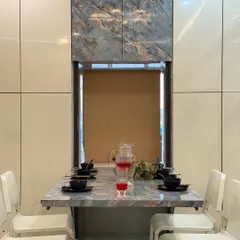 A close-up of our innovative foldable dining table, set for a meal. This space-saving furniture is perfect for maximizing floor space in urban homes without sacrificing style.