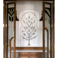 This sacred Puja room features a breathtaking custom marble inlay wall depicting the Tree of Life. The intricate craftsmanship is framed by elegant doors with tinted, patterned glass, creating a space that is both spiritual and exquisitely beautiful.