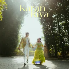 A happy, sun-drenched shot of a couple running hand-in-hand through a tree-lined path during their Haldi celebration, capturing the energy and fun of the day.