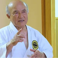 Grand Master Zenpo Shimabukuro, 10th Dan Hanshi, instructing students. His ability to explain complex principles is a hallmark of a true master, and his teachings form the curriculum of my dojo.