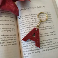 For those who love a bit of drama, this 'A' keychain is made with a bold poppy red shimmer. It’s a simple accessory that makes a statement.