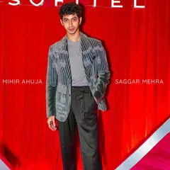 Here, the grey velvet coat is styled for a red carpet event. The plush velvet and detailed embroidery make it a statement piece that exudes luxury and sophistication.