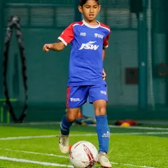 A young player demonstrates excellent balance and control while dribbling. Our training focuses on mastering the ball to build a solid technical base.
