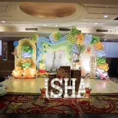 I brought the Hundred Acre Wood to life for this Winnie the Pooh themed event. The full stage setup includes character cutouts, a balloon arch mimicking trees and clouds, and illuminated letters spelling the baby's name, creating an immersive storybook experience.