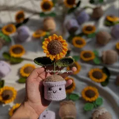 A single mini crochet sunflower pot with a cute smiling face. These little pots are designed to brighten up your desk or any small corner of your home.