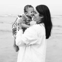 There's nothing more beautiful than the bond between a mother and her child. This black and white portrait from a beach session captures that pure, unscripted love.