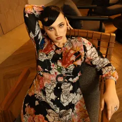 A relaxed yet chic pose in a modern setting. This type of shot is great for a lookbook, showing the outfit in a more natural, lifestyle context.