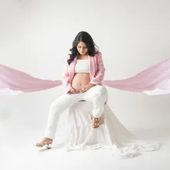 A touch of magic and elegance. This shot combines a modern pantsuit with flowing pink fabric, creating a dreamy and artistic portrait that is both stylish and soft.
