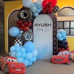 A closer look at our Cars-themed party decor. We use character cutouts and themed balloon arrangements with details like tires and checkered flags to create an immersive experience.